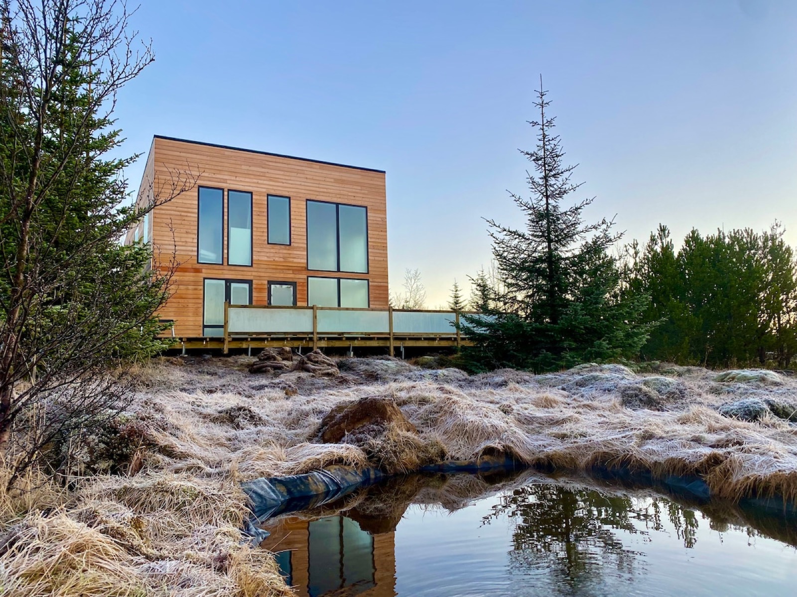 The villa seen across the geothermal water running below it