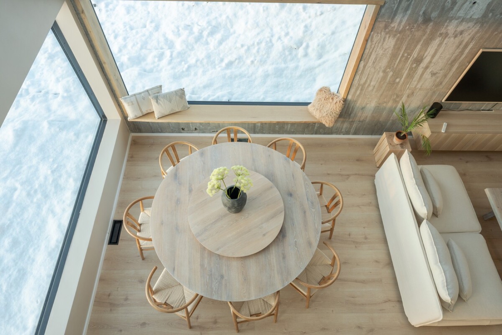 Angled clerestory glazing at the apex, seen from above the round dining table